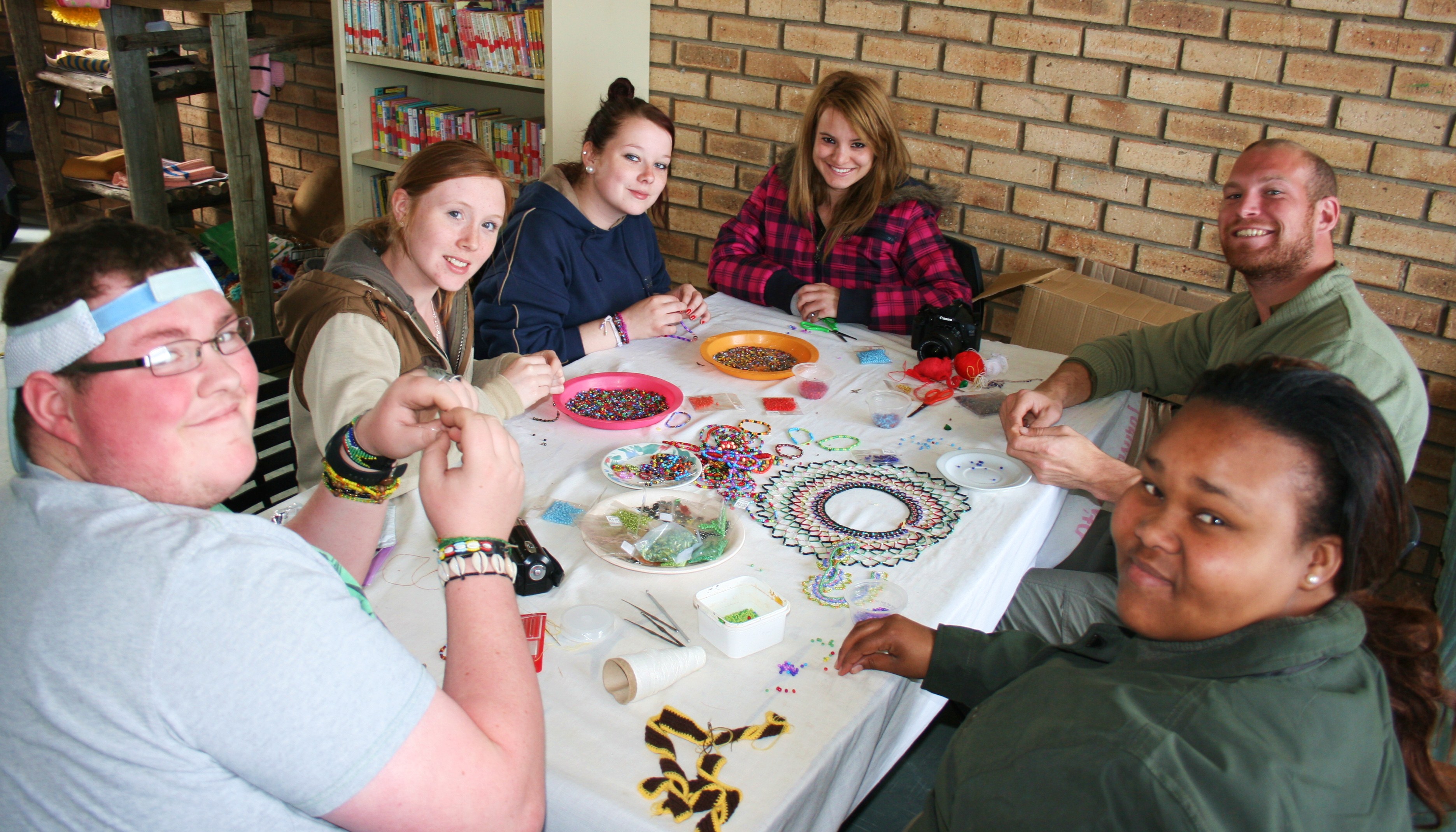 volunteers work with beads at the Addo old age home