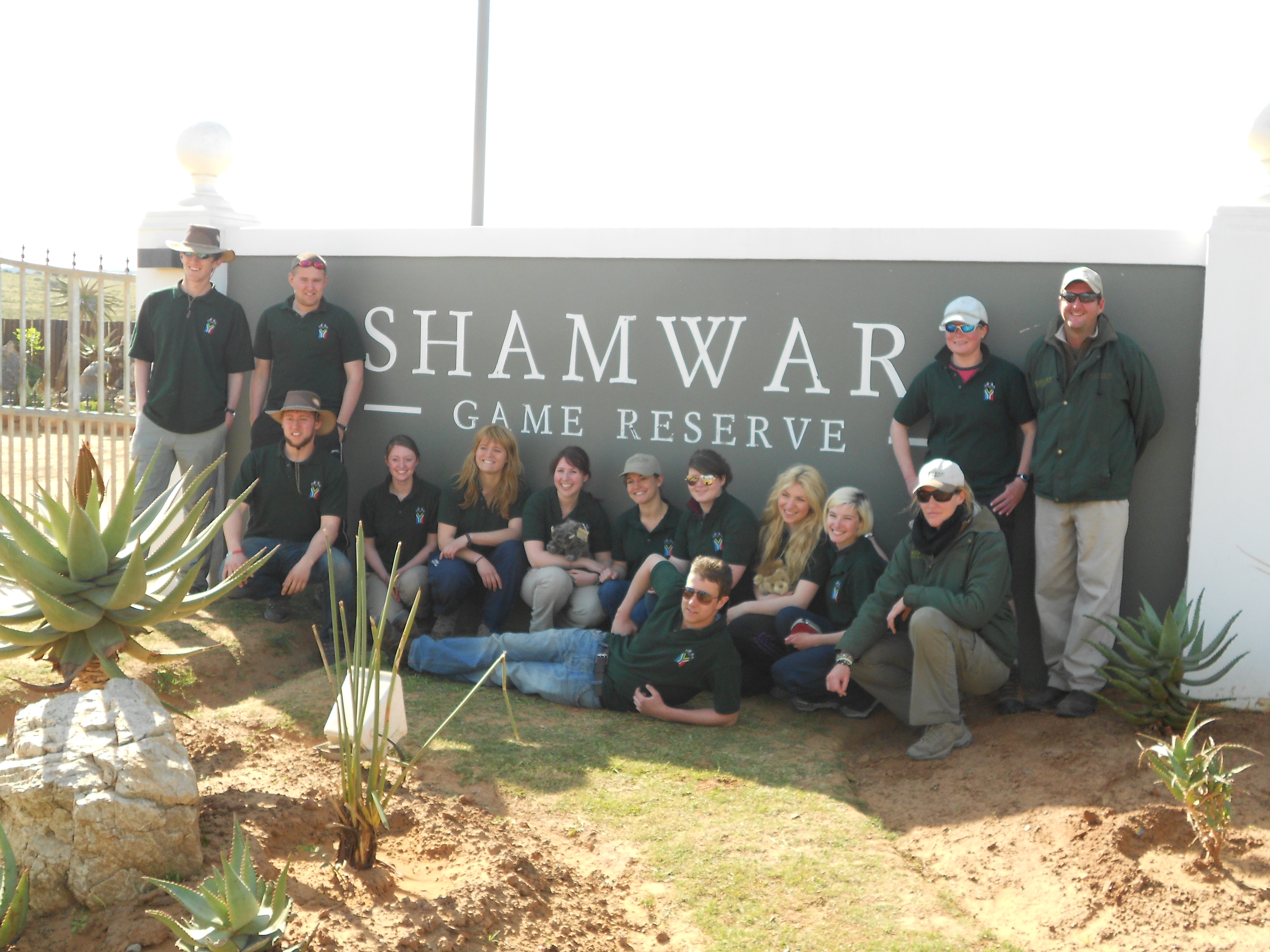 volunteers pose with the Shamwari Game Reserve sign
