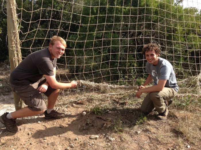 Volunteers setting up net on volunteer project