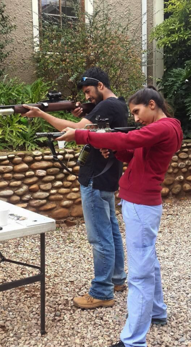 Two veterinary students practice their darting skills