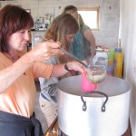 Volunteers pour soup into bowls