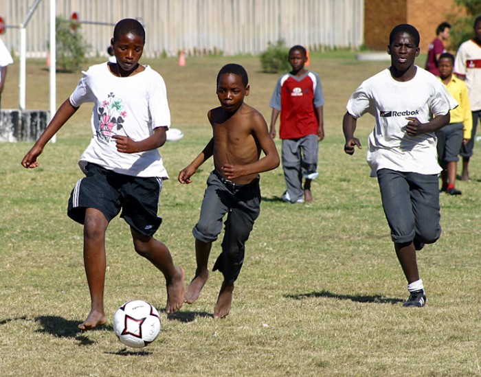 Local youths running with a football