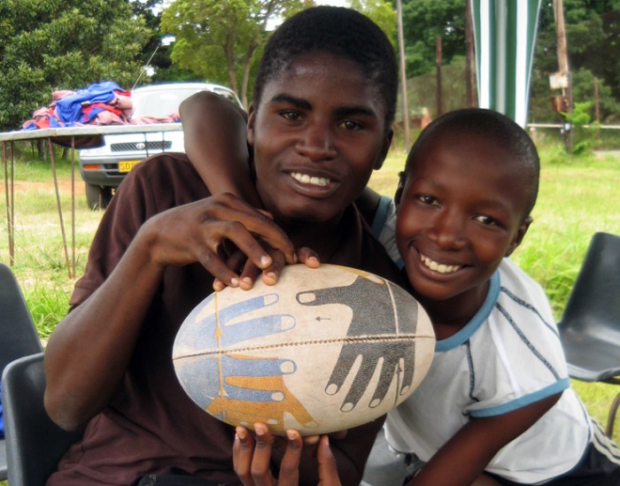A member of the local community holding a rugby ball
